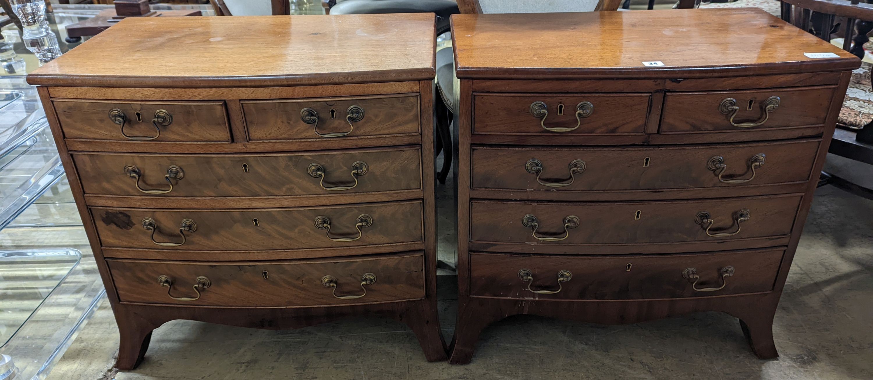 A pair of reproduction George III style bow fronted mahogany bedside chests, width 66cm, depth 39cm, height 64cm